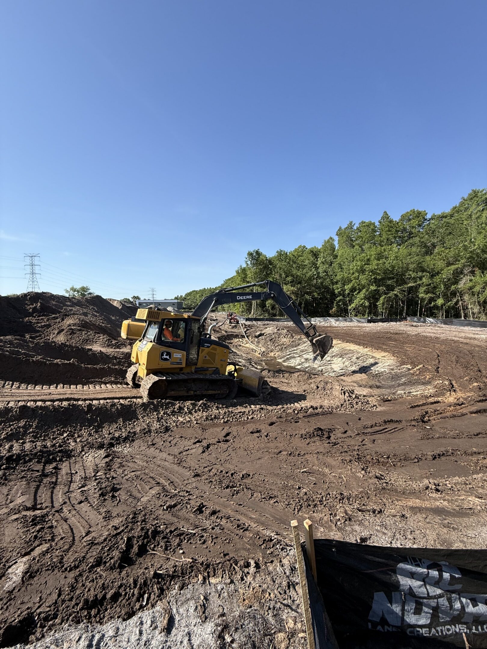 Yellow excavator digging dirt at construction site
