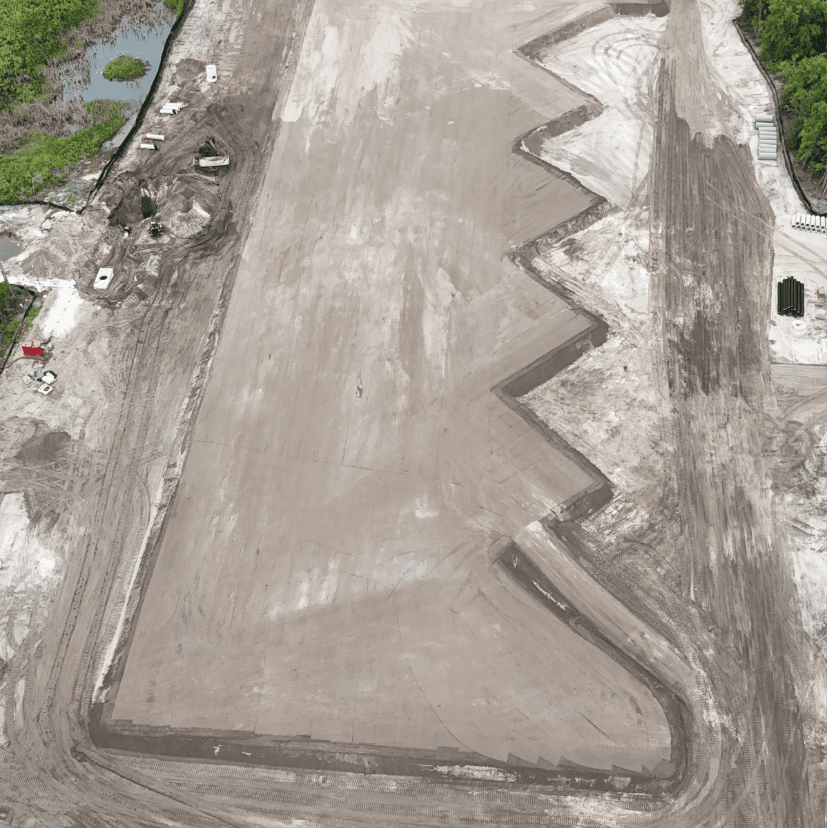 Aerial view of graded construction site with zigzag