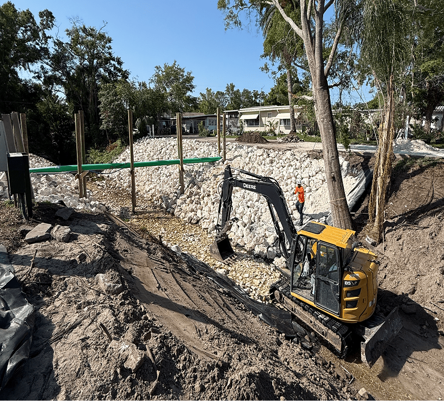Mini excavator at residential retaining wall construction