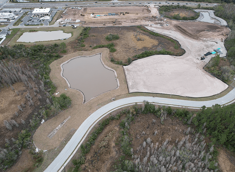 Aerial view of construction site with retention ponds